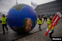 Protesters demonstrate during a rally ahead of the Paris Climate Summit, in Berlin, Germany, Nov. 29, 2015.