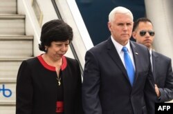 US Vice President Mike Pence is welcomed by Colombia's Foreign Affairs Vice Minister Luz Stella Jara upon arrival in Bogota, on Feb. 25, 2019.