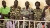 South Sudanese soldiers listen to the verdict being delivered at their trial in a military courtroom in Juba, Sept. 6, 2018. 