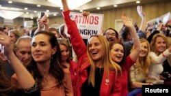 FILE - Supporters of the Republican nominee for governor of Virginia, Glenn Youngkin, react as Fox News declares Youngkin won his race against Democrat Terry McAuliffe, at a hotel in Chantilly, Va., Nov. 3, 2021.