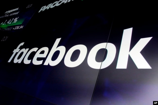 FILE - The logo for Facebook appears on screens at the Nasdaq MarketSite, in New York's Times Square, March 29, 2018.