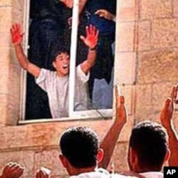 In a much circulated image, Abed al Aziz Salaha shows a cheering crowd his hands covered with blood of two killed Israelis (file photo).