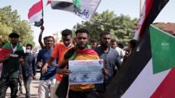 People chant slogans during a protest to denounce the October military coup, in Khartoum, Sudan, Dec. 25, 2021. Sudanese authorities tightened security across Khartoum, deploying troops and closing bridges over the Nile River.