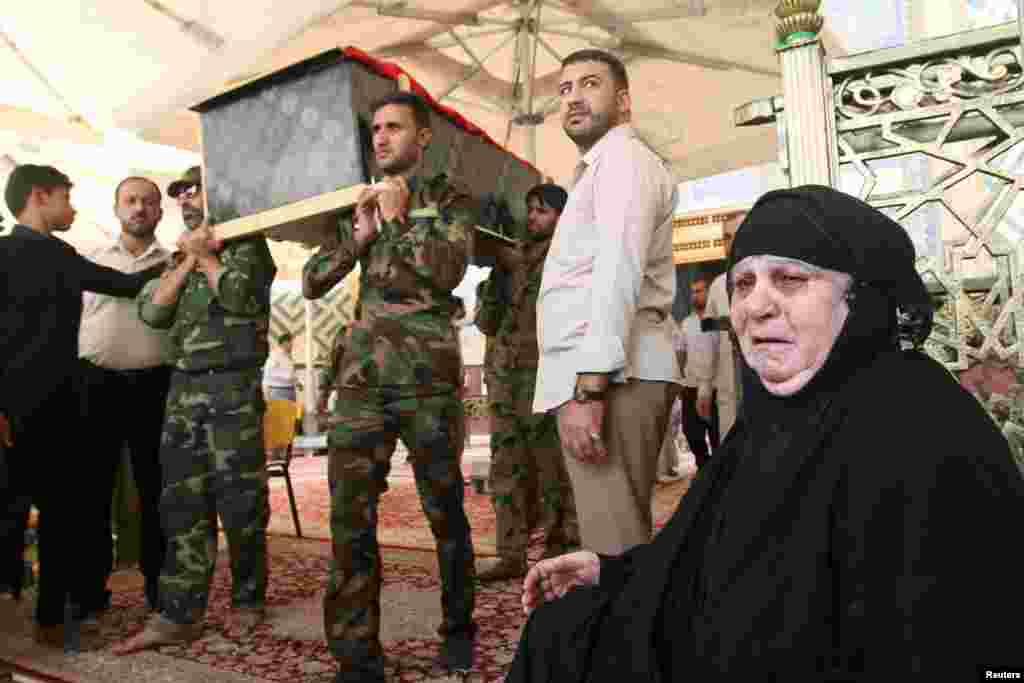 Mourners carry the coffin of their relative, who was killed in a suicide vehicle bomb in Karrada, Baghdad, during the funeral in Najaf, July 3, 2016.