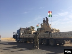 Tanks are transported on flatbed trucks to move them from one front to another swiftly, near Hassan Sham, Kurdistan, Iraq, Oct. 21, 2016. (Photo: H. Murdock / VOA)