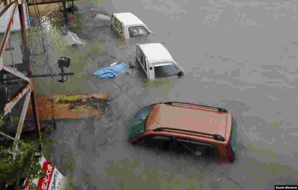 Stranded cars are seen in floodwater caused by Typhoon Halong in Kochi, western Japan, Aug. 10, 2014. 