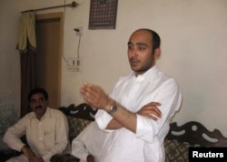 FILE - Ali Haider Gilani speaks during a campaign meeting at a house on the outskirts of Multan, May 9, 2013, before his abduction by unidentified gunmen.