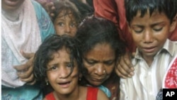 Pakistani family members mourn the death of a man who was shot dead in Karachi, Pakistan, July 8, 2011