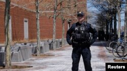 A police officer stands guard outside of John Joseph Moakley United States Courthouse in Boston, Massachusetts on May 1, 2013. 