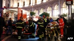 First responders evacuate wounded persons on Piazza della Repubblica in central Rome on Oct. 23, 2018, after at least 20 people were injured when an escalator leading to the Repubblica metro station collapsed.