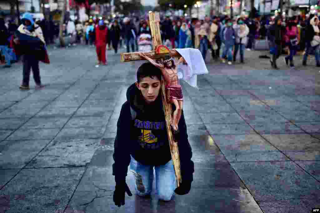 A penitent prays during the feast of the Virgin of Guadalupe, patron saint of Mexico, in Mexico City.