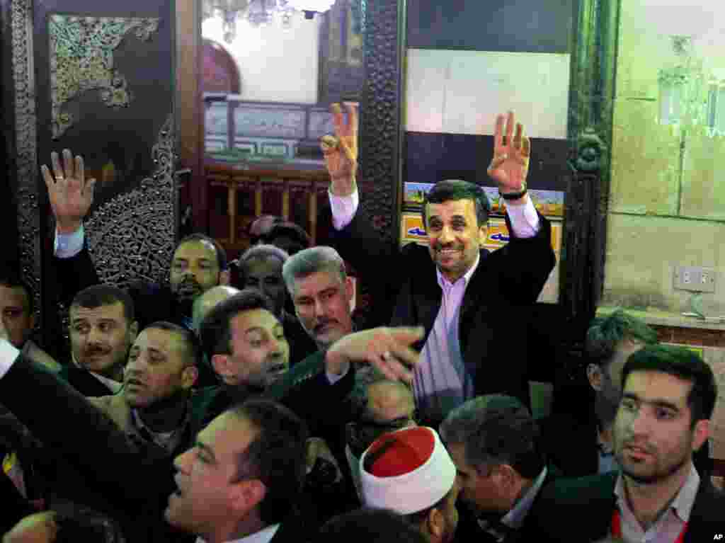Iran's President Mahmoud Ahmadinejad waves to Egyptian worshippers after he visits the shrine of Imam Hussein, the grandson of Islam's Prophet Mohammad, in Cairo, Egypt, February 5, 2013.