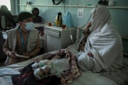 Islamia, 5-month-old and severely malnourished, lies on a bed at the neonatal intensive care unit of the Mirwais regional hospital.
