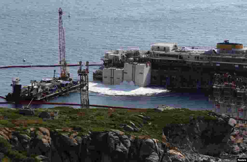 The Costa Concordia surrounded by tugboats during a refloat operation at Giglio harbour at Giglio Island, July 14, 2014.