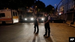 FILE - In this file photo dated Monday, June 19, 2017, police officers secure the area near Finsbury Park station after a vehicle struck pedestrians near a mosque in north London. A Crown Court on Thursday Feb. 1, 2018, found Darren Osborne guilty of murder and attempted murder in the June 2017 attack in the city's Finsbury Park neighborhood. 