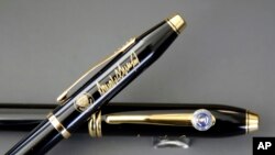 A.T. Cross Co. custom-made pens, designed for President Donald Trump, featuring his signature and presidential seals, are displayed at the Cross Company Store in Providence, R.I. Trump chose the Cross Century II model, top, over the Cross Townsend model, below.