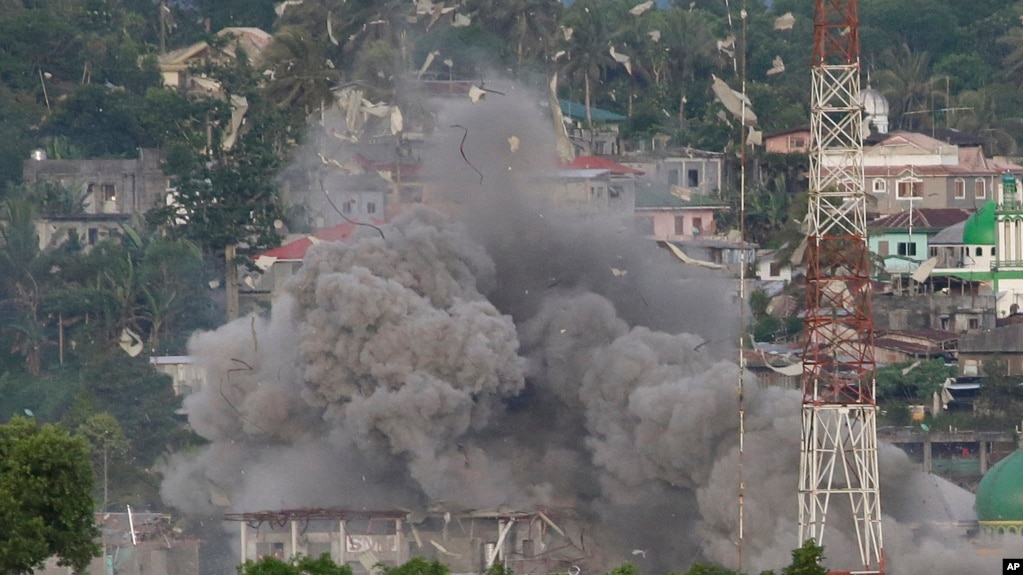 Debris flies as Philippine Air Force fighter jets bomb suspected locations of Muslim militants as fighting continues in Marawi city, southern Philippines, June 9, 2017. 