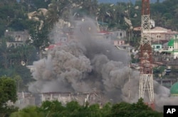 Debris flies as Philippine Air Force fighter jets bomb suspected locations of Muslim militants as fighting continues in Marawi city, southern Philippines, June 9, 2017.
