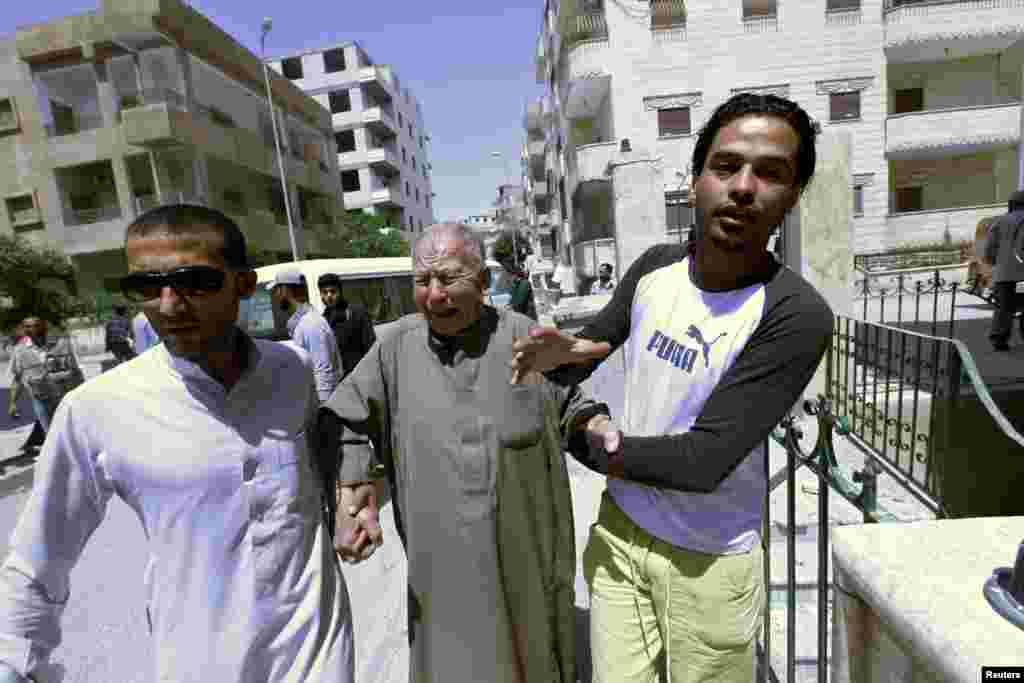 A man reacts after his grandson was injured during what activists said was shelling by forces loyal to Syrian President Bashar al-Assad, Raqqa province, Syria, May 2, 2013.