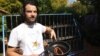 Zander Van Manen with sausages he cooked using heat from the sun. (Darren Taylor for VOA) 