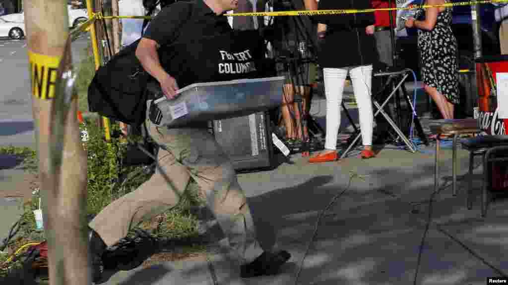 An investigator arrives at the Emanuel African Methodist Episcopal Church two days after a mass shooting left nine dead during a Bible study at the church in Charleston, S.C., June 19, 2015.