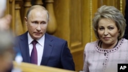 FILE - Russian President Vladimir Putin and Federation Council Speaker Valentina Matviyenko attend the Eurasian Women's Forum in St. Petersburg, Russia, Sept. 20, 2018. A report that Matviyenko would be leaving her post led to the journalists' firing. 