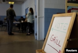 FILE - A voter checks in with workers at a polling station in Kershaw, S.C., Feb. 27, 2016. Democrats and Republicans compete in primaries and caucuses in at least 11 states and one U.S. territory Tuesday.