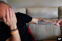 Mitch Dworet displays his tattoo of his oldest son Nick, a 17-year-old senior with a college swimming scholarship, who died in the Parkland shooting, on Feb. 5, 2019 in Coral Springs, Florida.