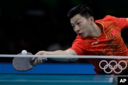 Ma Long of China plays against Quadri Aruna of Nigeria.during their Men's team table tennis first round match at the 2016 Summer Olympics in Rio de Janeiro, Brazil, Friday, Aug. 12, 2016.