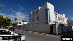 A police car is seen parked in front of the Tunisian embassy in Tripoli, Libya, April 17, 2014.