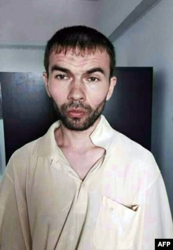 A handout photo from the Royal Thai police and released on August 29, 2015 shows the suspect which is being detained at a police station in Bangkok.