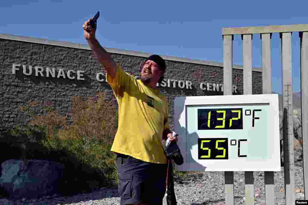 Greg Berndt takes a selfie with the thermometer reading 132&deg; F (55.5&deg; C) at the Furnace Creek Visitors Center in Death Valley, California, Aug. 17, 2020.