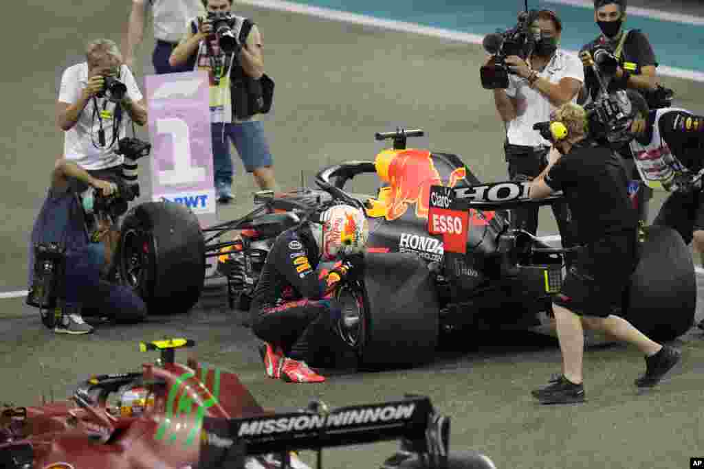 Red Bull driver Max Verstappen of the Netherlands kneels next to his car after winning the Formula One Abu Dhabi Grand Prix and&nbsp;after he became the world champion, in Abu Dhabi, United Arab Emirates.