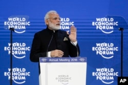 Prime Minister of India Narendra Modi greets the audience prior to his speech the World Economic Forum, WEF, in Davos, Switzerland, Tuesday, Jan. 23, 2018. (AP Photo/Markus Schreiber)