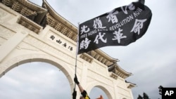 台灣民眾在台北自由廣場揮舞旗幟紀念百萬人反送中大遊行一周年並抗議港區國安法。（2020年6月13日）
