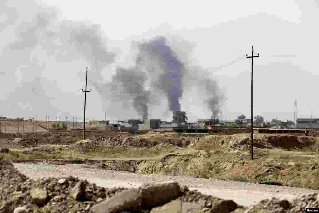 Smoke rises from Sulaiman Bek after fighters of the Asaib Ahl al-Haq Shi&#39;ite militia from the south of Iraq and Kurdish peshmerga forces took control of the town from Islamist State militants, in the northwest of Tikrit city, Sept. 1, 2014.