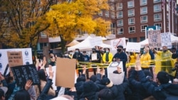 Pro-Thai democracy protesters make a three-finger salute during a clash between pro-democracy protesters and royalists during the demonstration at King Bhumibol Adulyadej Square in Cambridge, MA Nov 1, 2020.