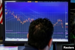 A trader looks at a screen on the floor of the New York Stock Exchange, (NYSE) in New York, Feb. 6, 2018.