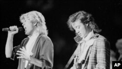 FILE - The pop duo Wham! performs in Peking before a capacity audience of Chinese and foreign fans, April 7, 1985.