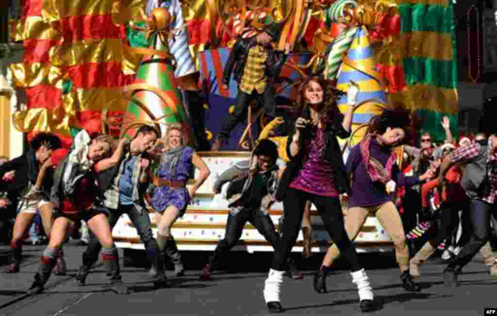 In this publicity image released by Disney, actress and singer Debby Ryan, star of Disney Channel's "The Suite Life on Deck," foreground, performs on Thursday, Dec. 2, 2010 while taping a segment for the "Disney Parks Christmas Day Parade" at the Magic Ki
