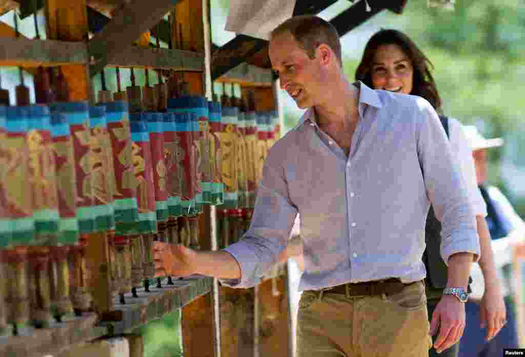 Britain&#39;s Prince William, Duke of Cambridge and his wife Catherine, Duchess of Cambridge, spin prayer wheels at the Paro Taktsang Monastery, Bhutan. The royal couple are on a seven-day tour of India and Bhutan.