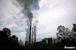 FILE - Exhaust rises from the stacks at a coal-fired electricity-generating power station in Haywood, West Virginia, May 16, 2018.