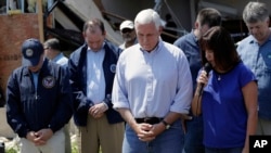 Vice President Mike Pence, center, and other bow their heads as his wife, Karen prays during a visit to the First Baptist Church of Rockport, Aug. 31, 2017, in Rockport, Texas. The church received heavy damage from Hurricane Harvey.