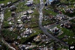 FILE - Destroyed communities are seen in the aftermath of Hurricane Maria in Toa Alta, Puerto Rico, Sept. 28, 2017.