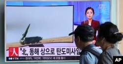 FILE - People watch a TV news program reporting about a North Korean missile launch, at the Seoul Train Station in Seoul, South Korea, Sept. 5, 2016.