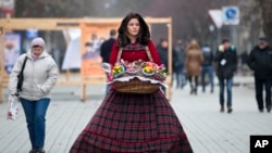 A flower vendor walks downtown Simferopol, Ukraine, March 9, 2014.