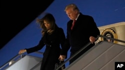 President Donald Trump and first lady Melania Trump alight from Air Force One, after arriving at Orly airport near Paris, Nov. 9, 2018. 