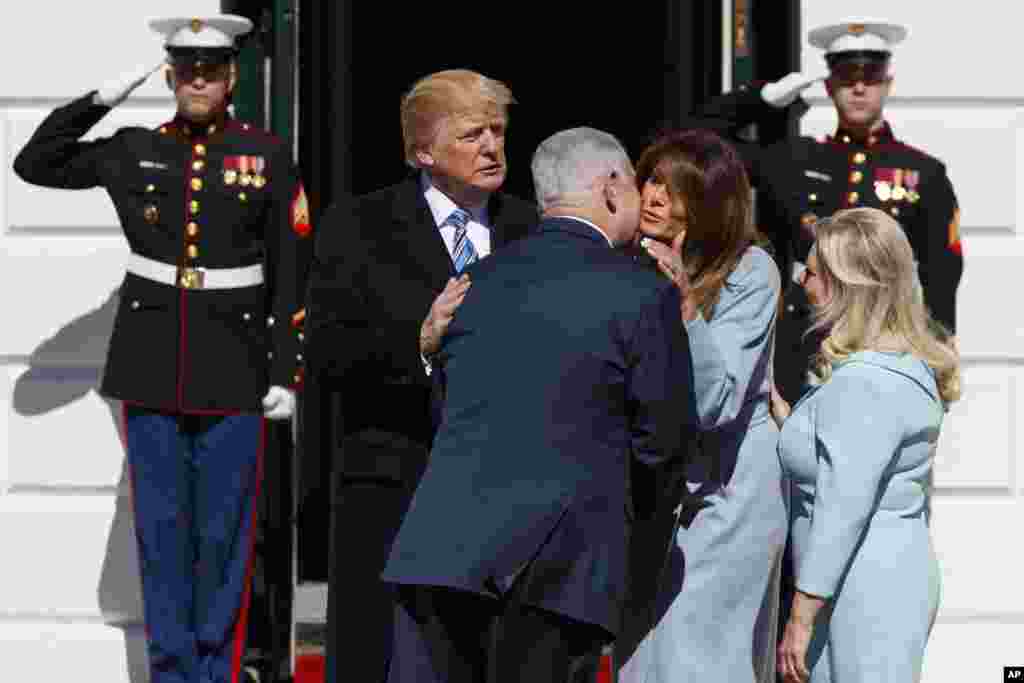 President Donald Trump and first lady Melania Trump greet Israeli Prime Minister Benjamin Netanyahu and his wife Sara Netanyahu at the White House in Washington.