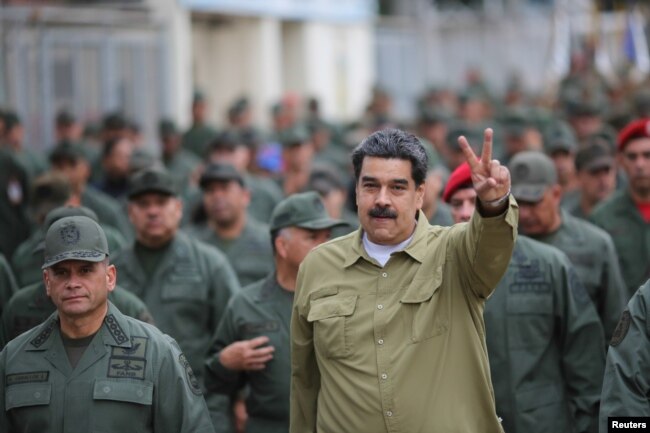 Venezuela's President Nicolas Maduro gestures during a meeting with soldiers at a military base in Caracas, Venezuela, Jan. 30, 2019.