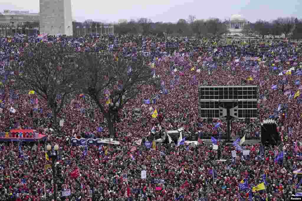 With the Washington Monument in the background, people attend a rally in support of President Donald Trump near the White House in Washington.